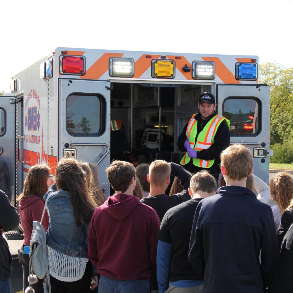 Group of students next to an ambulance